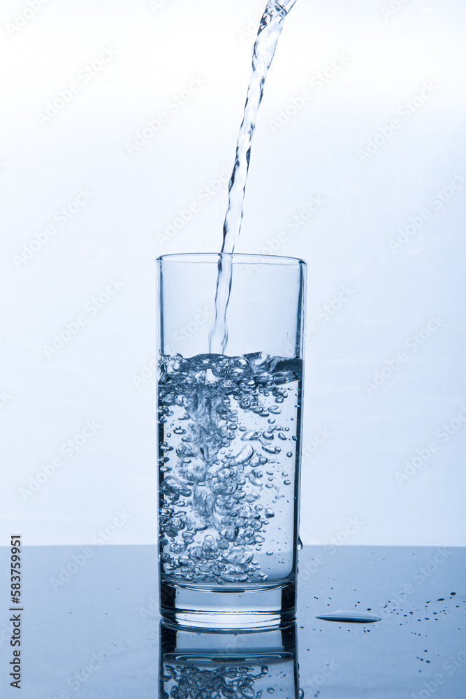 drinking water pouring into glass on white background drinking water pouring into glass on white background