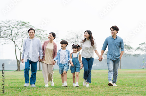 Asian family photo walking together in the park