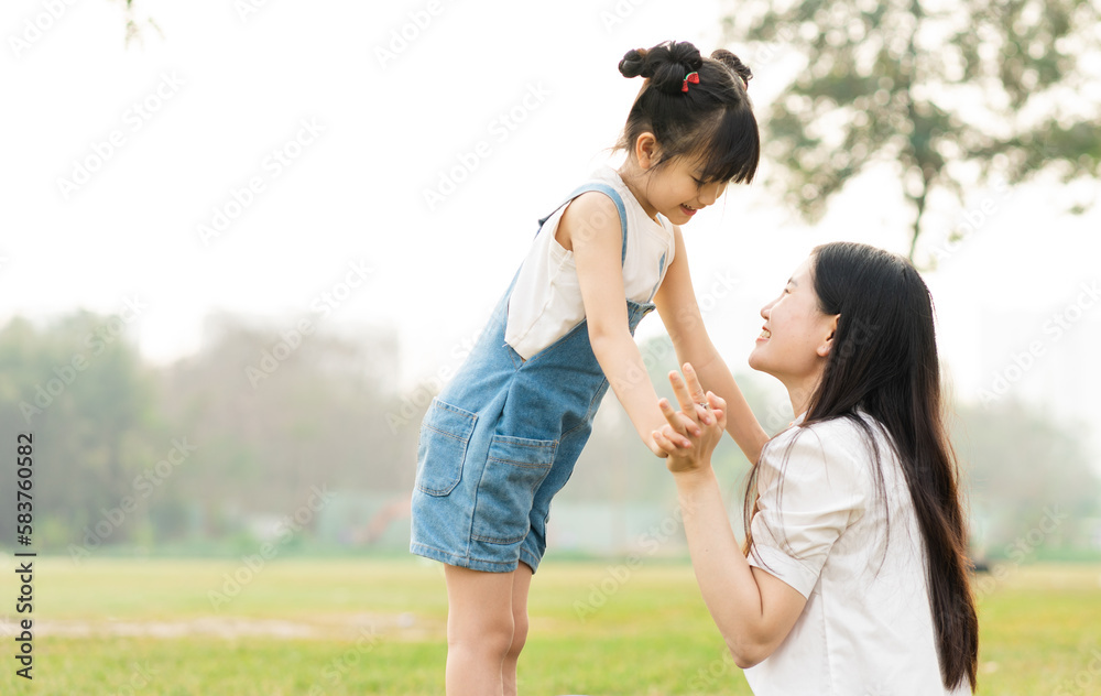 image of mother and daughter playing in the park image of mother and daughter playing in the park