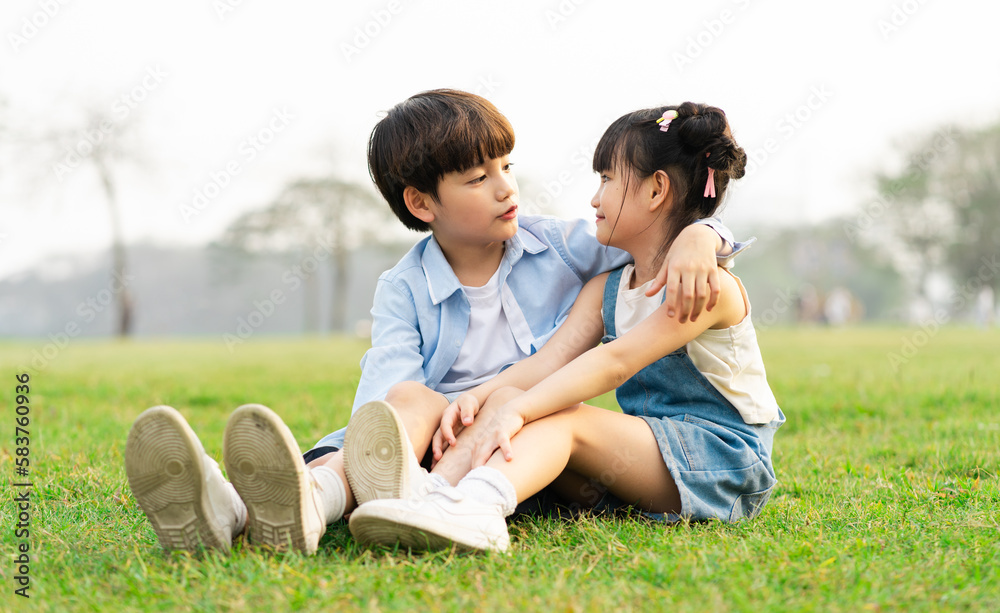 image of brother and sister having fun in the park image of brother and sister having fun in the park