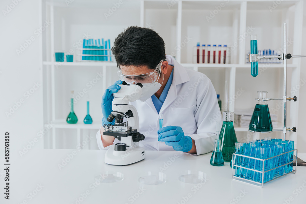 Young scientist looking through a microscope in a laboratory. Young scientist doing some research. Young scientist looking through a microscope in a laboratory. Young scientist doing some research.