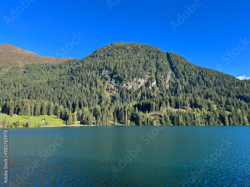 Alpine mountain Seehorn (2238 m) covered with evergreen forest above the tourist and sports mountain lake Davos or Davosersee, Davos Dorf - Canton of Grisons, Switzerland (Kanton Graubünden, Schweiz) photo