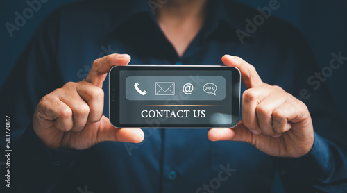 Woman hand using smart phone, Contact us connection concept. Contact us or Customer support hotline people connect. virtual screen contact icons ( email, address, live chat, internet wifi ).