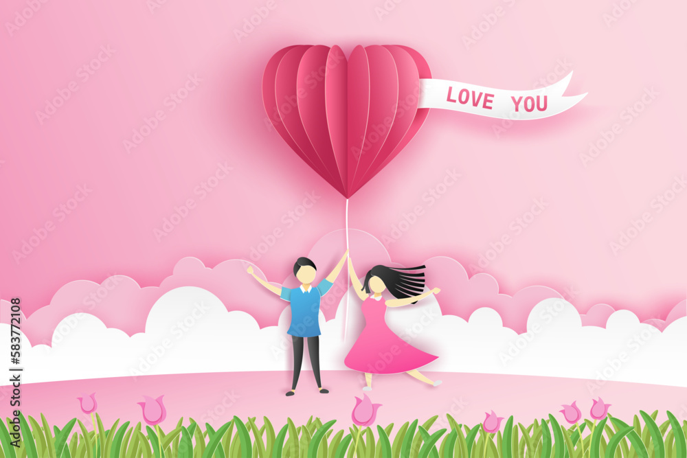 Lovely couple holding a pink hot air balloon in heart shape on meadow ...