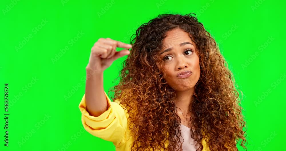 Small, size and green screen with woman face feeling sad with studio background. Hands, tiny measurement and fingers of a young female model with review, opinion and hand pinch and gesturing sign