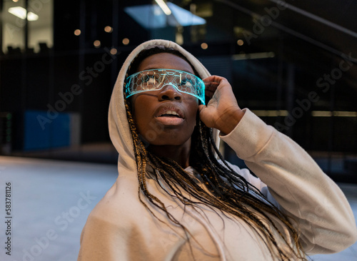 African woman wearing futuristic virtual reality goggles, plunged into a world of endless possibilities and boundless creativity.
