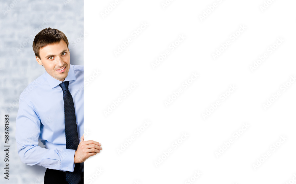 Portrait image of business man professional bank manager in confident cloth, necktie stand behind show empty white banner signboard billboard with copy space area. White bricks wall background. Portrait image of business man professional bank manager in confident cloth, necktie stand behind show empty white banner signboard billboard with copy space area. White bricks wall background.
