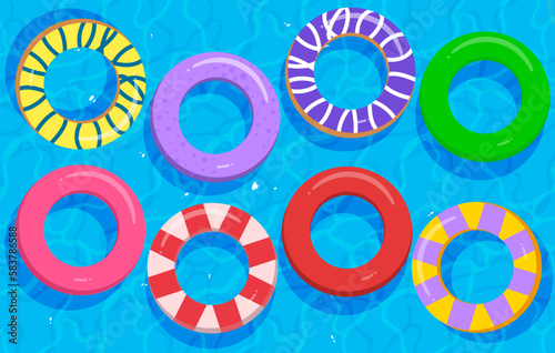 Top view of the swimming pool with colorful floating inflatable circle floaters perfect for summer. 