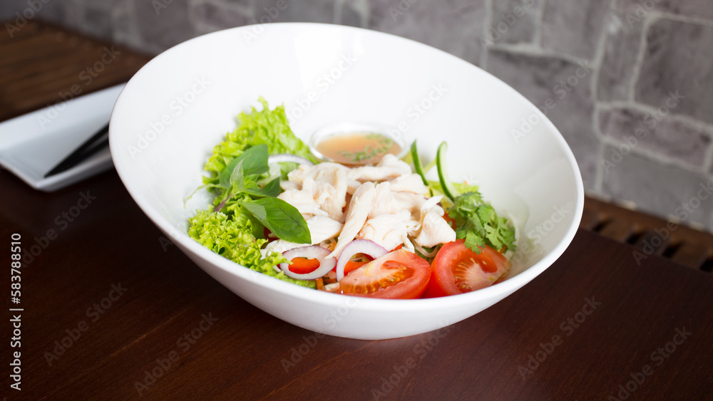 Delicious Asian salad with boiled chicken, tomatoes and lettuce Delicious Asian salad with boiled chicken, tomatoes and lettuce