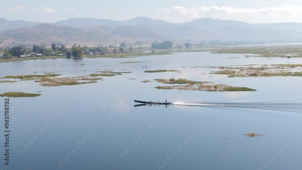 Aerial tracking shot of speeding Long Boat on Inle Lake in Myanmar Aerial tracking shot of speeding Long Boat on Inle Lake in Myanmar