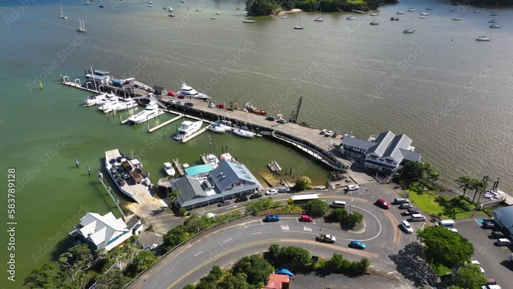 aerial view of bay of islands New Zealand with ferry port and sail boat on the ocean cursing the archipelago islands in NZ aerial view of bay of islands New Zealand with ferry port and sail boat on the ocean cursing the archipelago islands in NZ