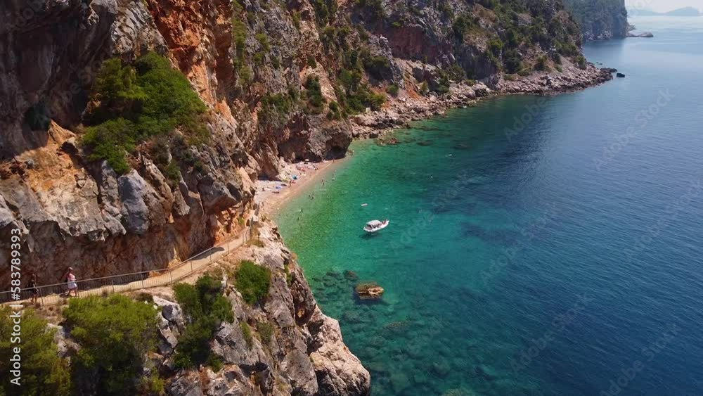 Slow Aerial View Of A Small Isolated Beach In Croatia With Turquoise Crystal Clear Water, Small Boats And Pittoresque Mountainscape, Pasjača Beach, Mediterranean Sea Slow Aerial View Of A Small Isolated Beach In Croatia With Turquoise Crystal Clear Water, Small Boats And Pittoresque Mountainscape, Pasjača Beach, Mediterranean Sea
