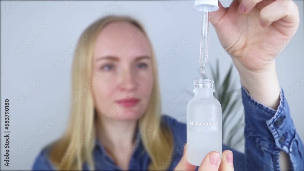 Niacinamide. Girl applies vitamin b3 to her face. Laboratory research. Skincare. Dermatological serum. Emulsion for narrowing of pores, normalization of sebum production and lightening of pigmentation
