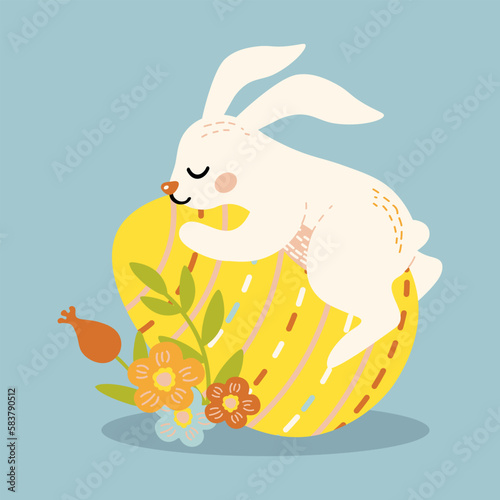 cute rabbit lies on a big easter egg