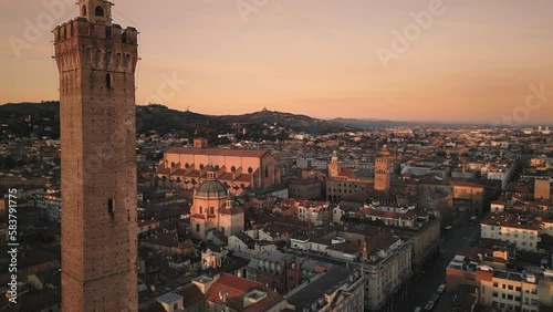 bologna city center aerial view drone at sunrise,flying forward close to asinelli tower at dawn photo