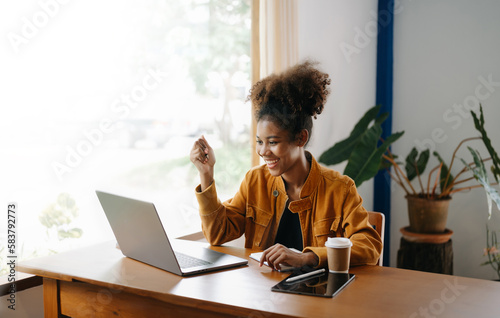 African woman are delighted and happy with the work they do on their tablet, laptop and taking notes at the office..