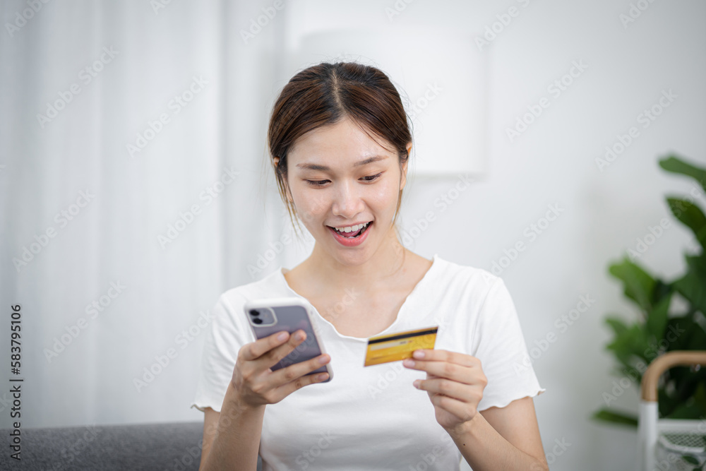 Woman holding credit card and using laptop computer for Internet online e-commerce shopping spending money Online shopping laptop technology concept . Online shopping pay by credit card concept Woman holding credit card and using laptop computer for Internet online e-commerce shopping spending money Online shopping laptop technology concept . Online shopping pay by credit card concept
