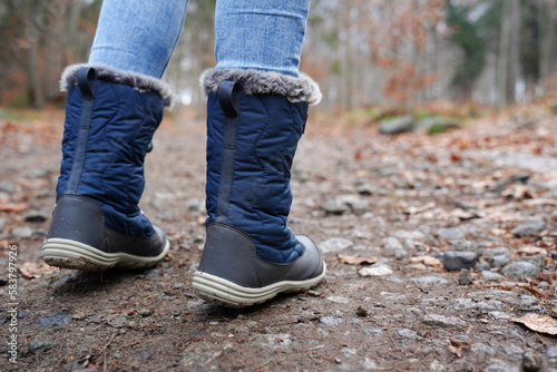 Rear view of traveler in hiking boot on the ground. Outdoors activity