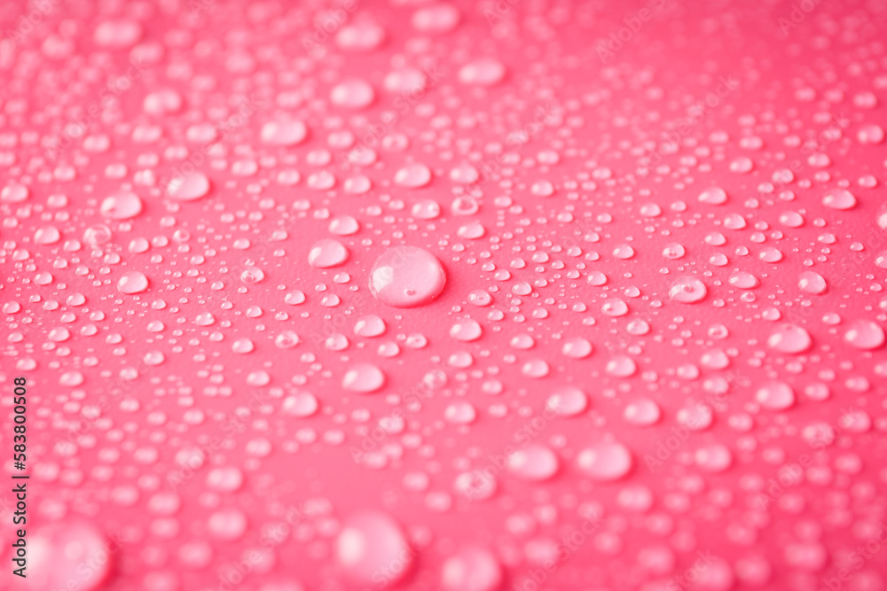 Pink background with water drops, close up Pink background with water drops, close up