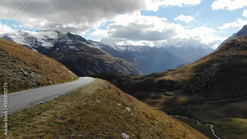 Panoramic road on Col de l'Iseran with landscape in background, France. Aerial drone flight low