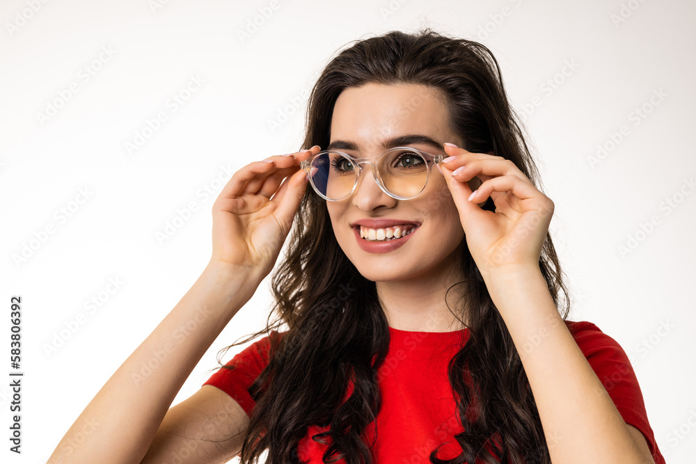 Smiling brunette woman in eyeglasses over white background Smiling brunette woman in eyeglasses over white background