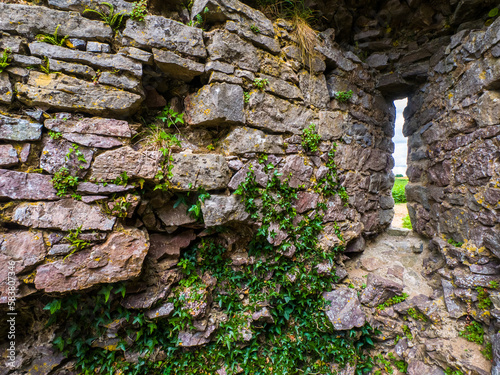 Arrowslit remaining in a wreckage of old castle (Wales, United Kingdom) photo