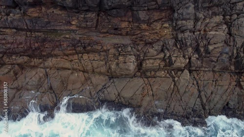 Rugged Cliffs And Ocean Waves In Arteixo, Spain - aerial top down photo