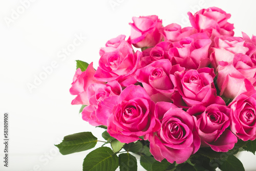 Beautiful bunch of fresh pink roses in full bloom against white background  close up. Bouquet of flowers. Valentine s day or Mother s day card.