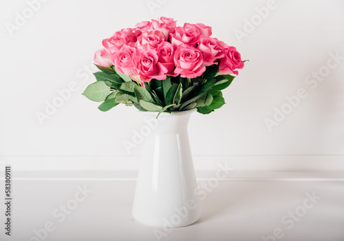Beautiful bunch of fresh pink roses in full bloom against white background. Bouquet of flowers. Valentine's day or Mother's day card.