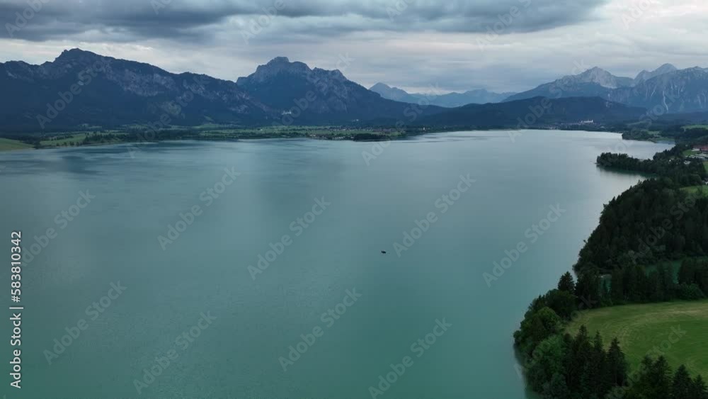 Forggensee, Bavaria. Aerial tilt-up shot from the water of the beautiful lake next to the alps up to the horizon. Forggensee, Bavaria. Aerial tilt-up shot from the water of the beautiful lake next to the alps up to the horizon.