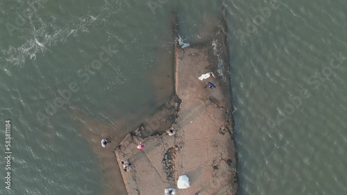 Drone footage above the old pier in ruins of the Sekong river in Stung Treng city. Camera film the ground and looks fowards 6-6 photo