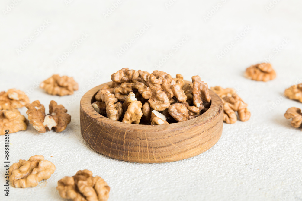 Fresh healthy walnuts in bowl on colored table background. Top view Healthy eating bertholletia concept. Super foods