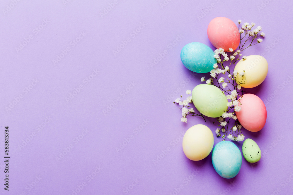 Happy Easter composition. Easter eggs on colored table with gypsophila. Natural dyed colorful eggs background top view with copy space Happy Easter composition. Easter eggs on colored table with gypsophila. Natural dyed colorful eggs background top view with copy space