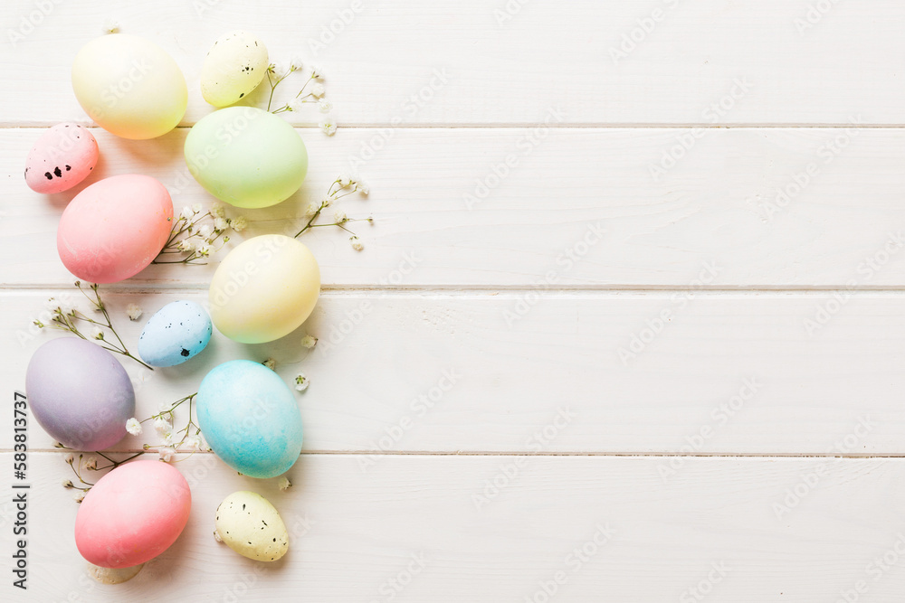 Happy Easter composition. Easter eggs on colored table with gypsophila. Natural dyed colorful eggs background top view with copy space Happy Easter composition. Easter eggs on colored table with gypsophila. Natural dyed colorful eggs background top view with copy space