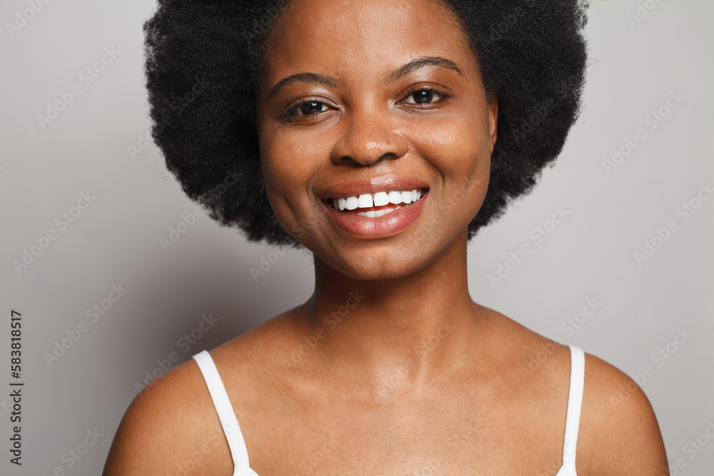 Pretty woman face with cute smile with natural white teeth closeup studio portrait