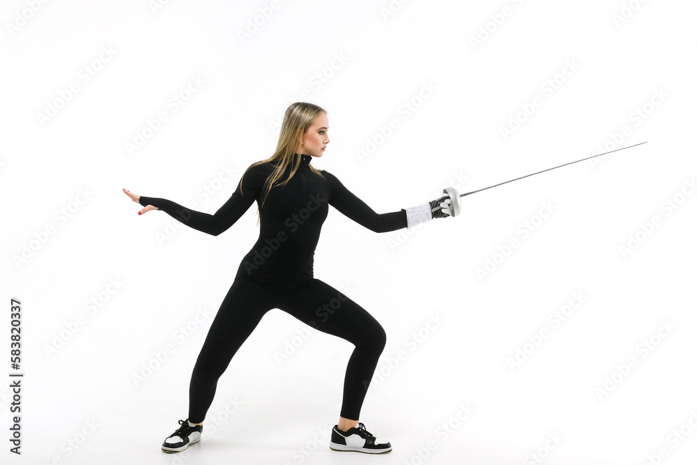 Girl in a black tight-fitting jumpsuit practicing with a sword on a white background Girl in a black tight-fitting jumpsuit practicing with a sword on a white background
