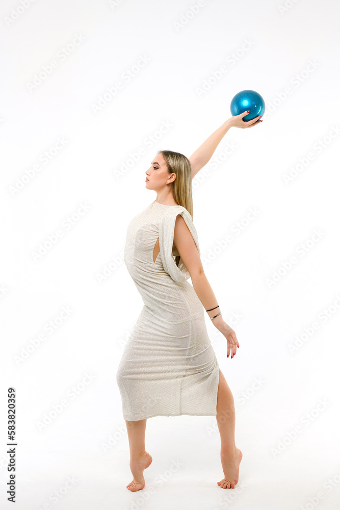 Gymnast dressed in evening dress with ball on white background Gymnast dressed in evening dress with ball on white background