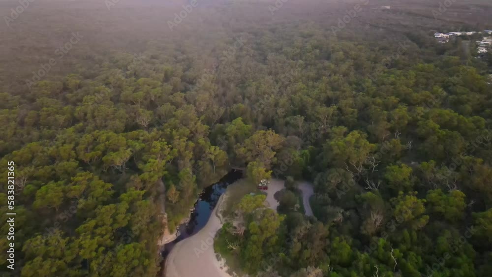 Aerial drone view of Currarong village in the City of Shoalhaven on the shores of Jervis Bay, NSW, Australia, showing Currarong Creek in the late afternoon Aerial drone view of Currarong village in the City of Shoalhaven on the shores of Jervis Bay, NSW, Australia, showing Currarong Creek in the late afternoon