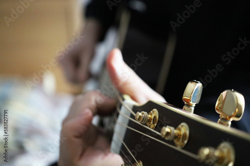 beautiful guitar in the hands of men playing the instrument