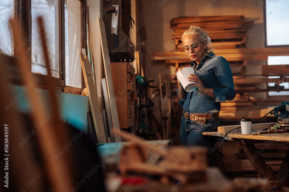 Female carpenter having lunch at work. Female carpenter having lunch at work.