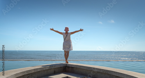 A female tourist is excited at the infinity pool overlooking the sea at the four-star Quynh Vien Resort, Ha Tinh provice, Vietnam