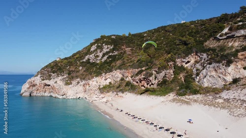 Aerial view of para glider flying over tropical sea in summer season on Milos beach on Lefkada island.