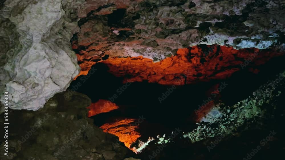 Excursion to the dark ice cave in winter. Underground large stone cave. Tourism in Russia, the concept of speleology. Kungur ice cave. Perm Region. Matte illuminated walls in an Ice Cave. 4k Excursion to the dark ice cave in winter. Underground large stone cave. Tourism in Russia, the concept of speleology. Kungur ice cave. Perm Region. Matte illuminated walls in an Ice Cave. 4k