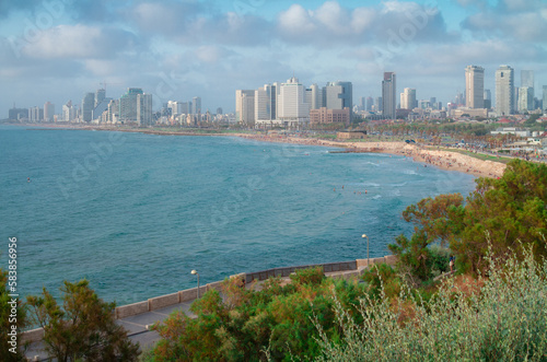 Tel Aviv panorama: high skyscrapers, blue sea, beach and green gardens