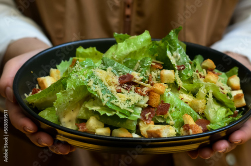 Caesar salad with croutons and parmesan cheese. Fresh caesar salad on plate 