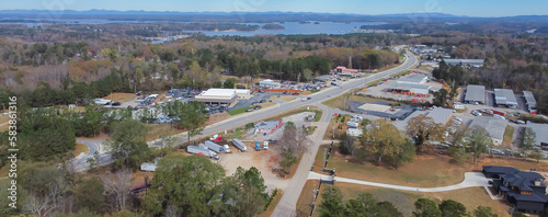 Panorama aerial view Lanier Island Parkway with farm ranch style residential houses, commercial buildings and Lake Lanier in background in Buford, America photo