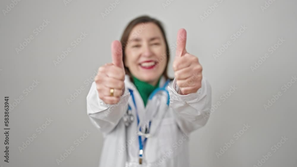 Mature hispanic woman with grey hair doctor doing thumbs up over isolated white background Mature hispanic woman with grey hair doctor doing thumbs up over isolated white background
