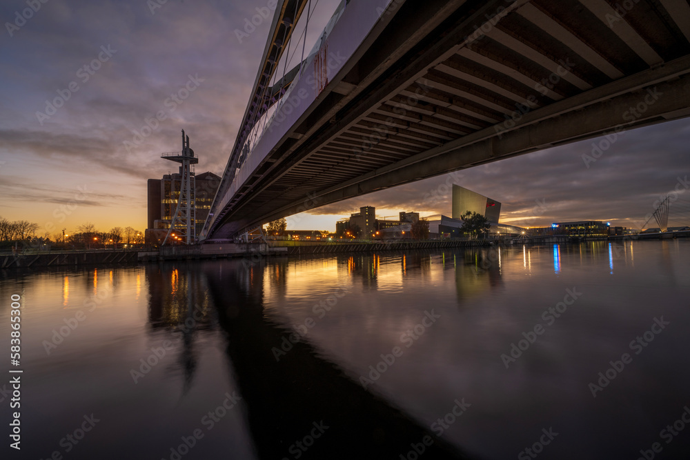 Footbridge and Imperial War Museum North at night, Salford Quays, Manchester, England Footbridge and Imperial War Museum North at night, Salford Quays, Manchester, England
