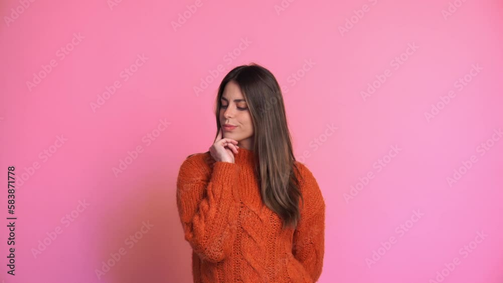 Dreamy woman in sweater looking at camera in studio Dreamy woman in sweater looking at camera in studio