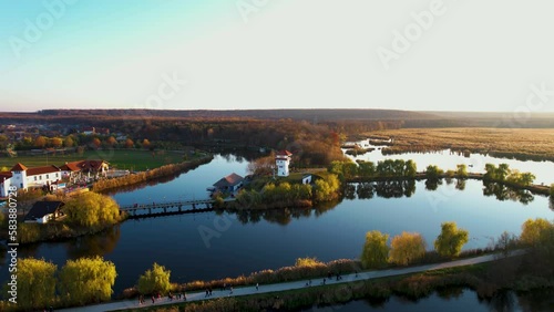 Serene Sunset Drone View of Comana Natural Park Delta- A Picturesque Landscape with Lush Vegetation and Charming Buildings, Romania photo